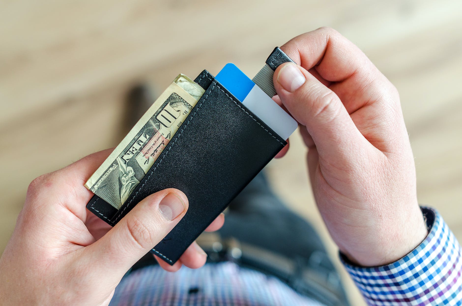 person holding black card holder