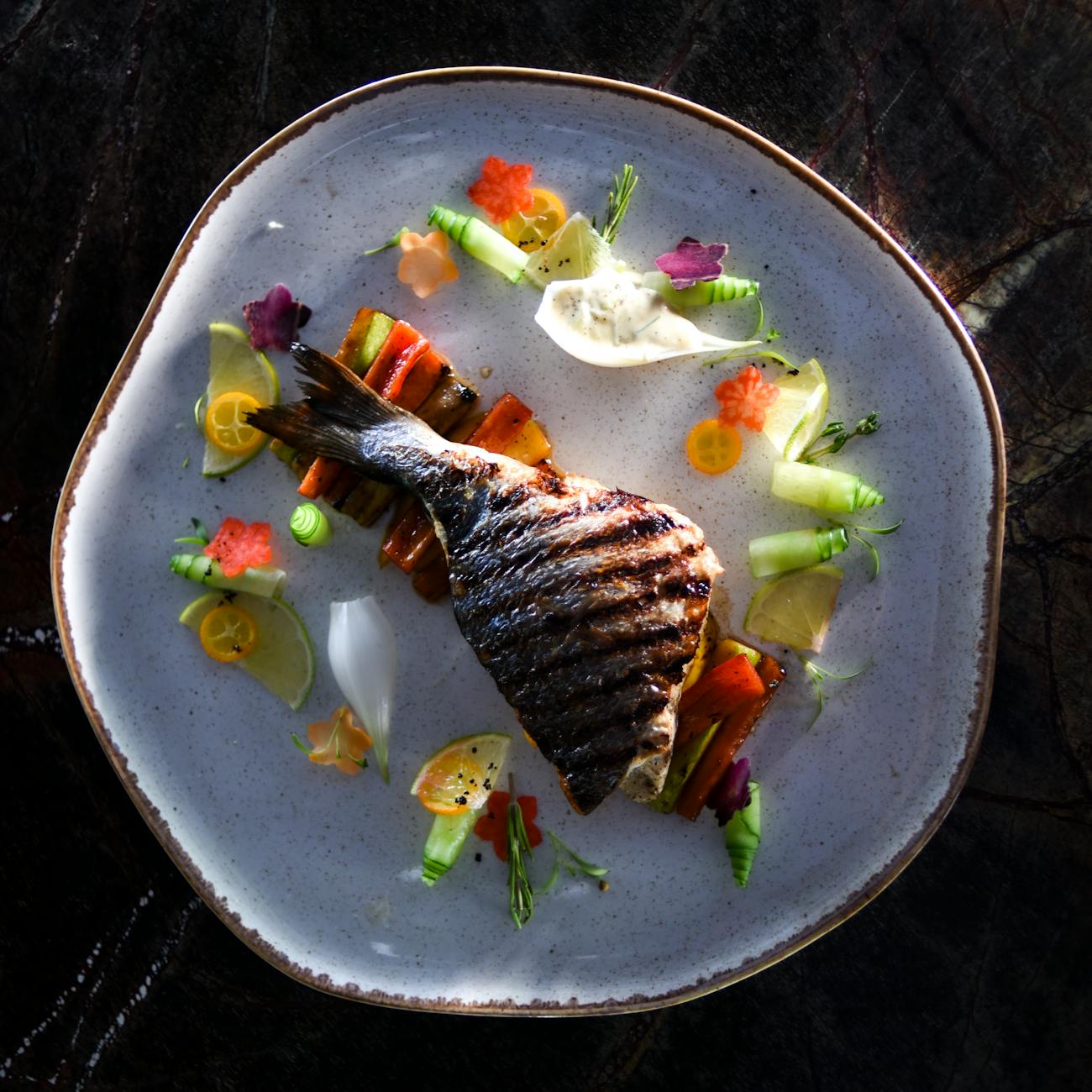 grilled fish served on a ceramic plate